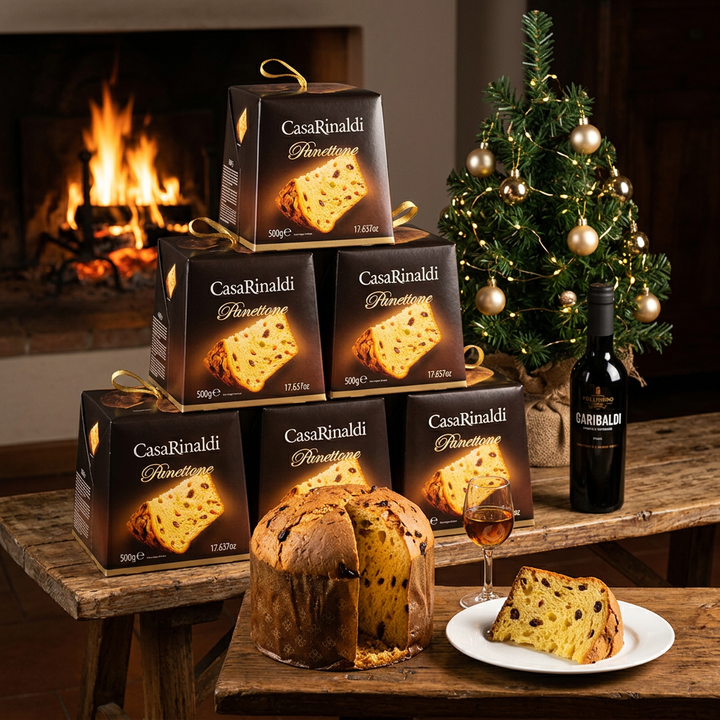 Six Casa Rinaldi panettone boxes stacked beside a Christmas tree, with sliced panettone and Pellegrino Garibaldi Marsala by a glowing fireplace.
